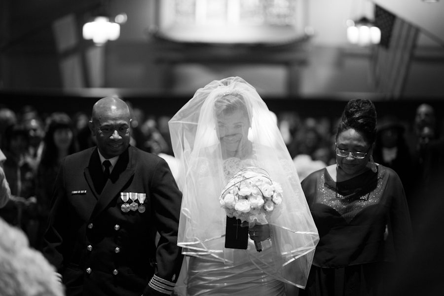 Bride and parents walk down the aisle at St. George's Episcopal Church in Maplewood, NJ. Captured by NJ wedding photographer Ben Lau.