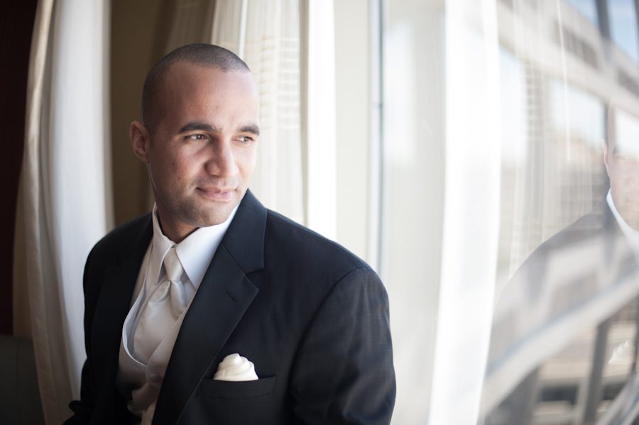 Groom poses by the window on the morning of his wedding at the Marriott Crystal City in Arlington VA. Caputred by Northern Virginia wedding photographer Ben Lau.