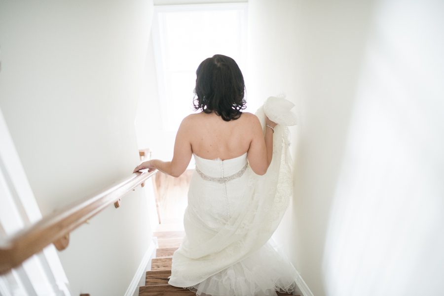 Bride descends the stairs on her way to her wedding at Mercer Oaks in Princeton Junction, NJ. Captured by NJ wedding photographer Ben Lau.