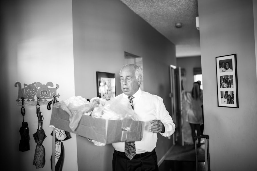 Father of the bride carries flowers for a wedding at The Mill in Spring Lake Heights, NJ. Captured by northern NJ wedding photographer Ben Lau.