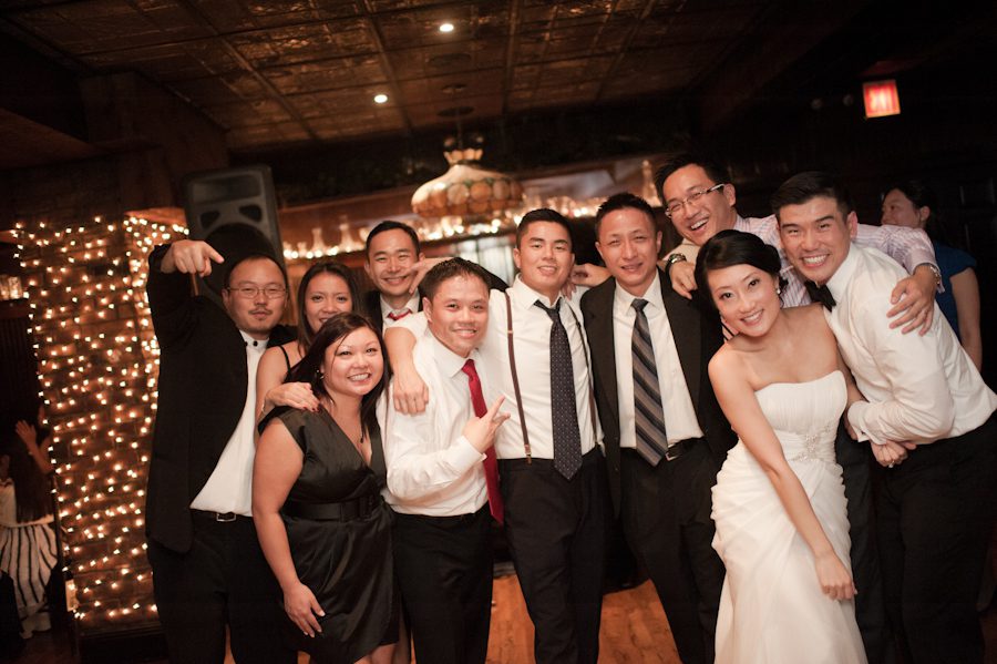 Guests pose for a photo during a wedding at Morans in Chelsea, NY. Captured by NYC wedding photographer Ben Lau.