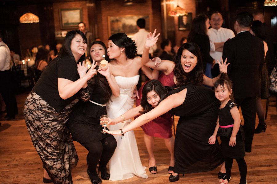 Guests pose for a picture during a wedding at Morans in Chelsea, NY. Captured by NYC wedding photographer Ben Lau.