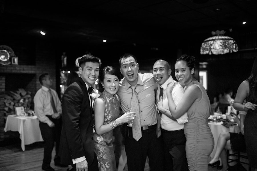 Wedding photographer Ben Lau poses with two of his couples during a wedding at Morans in Chelsea, NY. Captured by NYC wedding photographer Ben Lau.