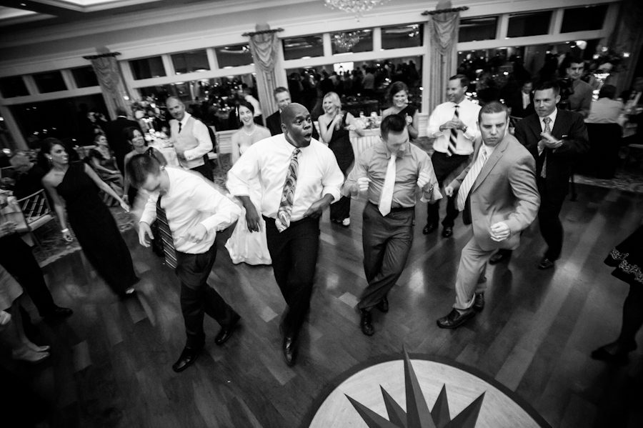 Guests dance during a wedding reception at Clarks Landing in Point Pleasant, NJ. Captured by northern NJ wedding photographer Ben Lau.
