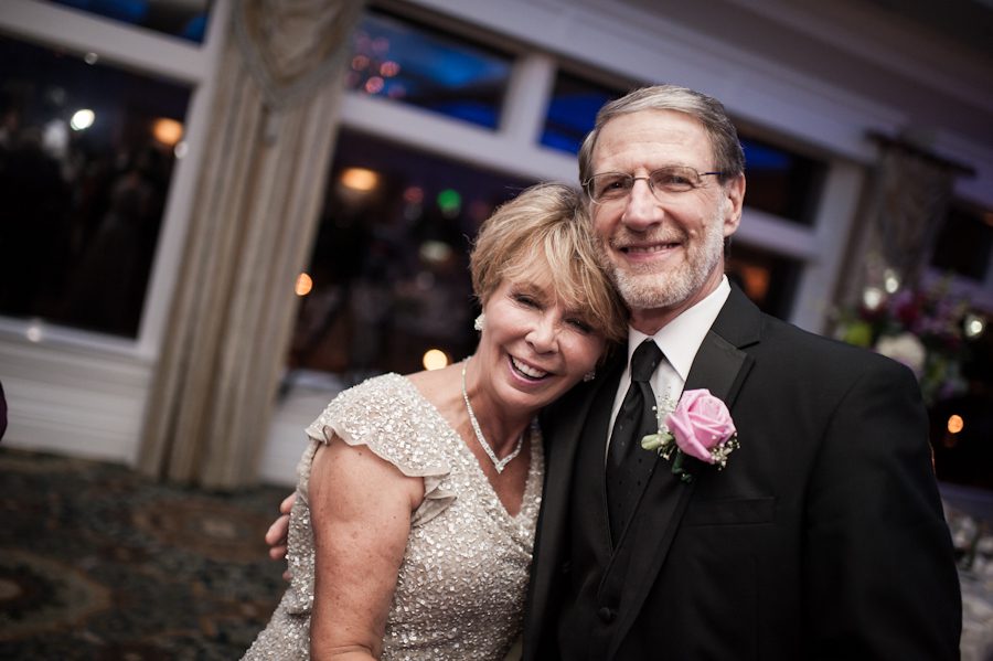 Parents of the groom pose for a picture during their wedding reception at Clarks Landing in Point Pleasant, NJ. Captured by northern NJ wedding photographer Ben Lau.