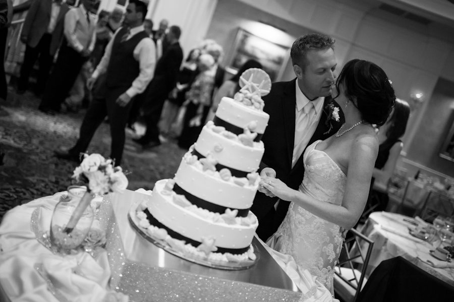 Cake cutting during a wedding reception at Clarks Landing in Point Pleasant, NJ. Captured by northern NJ wedding photographer Ben Lau.