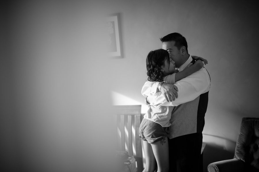 Groom and future daughter share a hug on the morning of their wedding day in Brooklyn, NY. Captured by Ben Lau Photography.