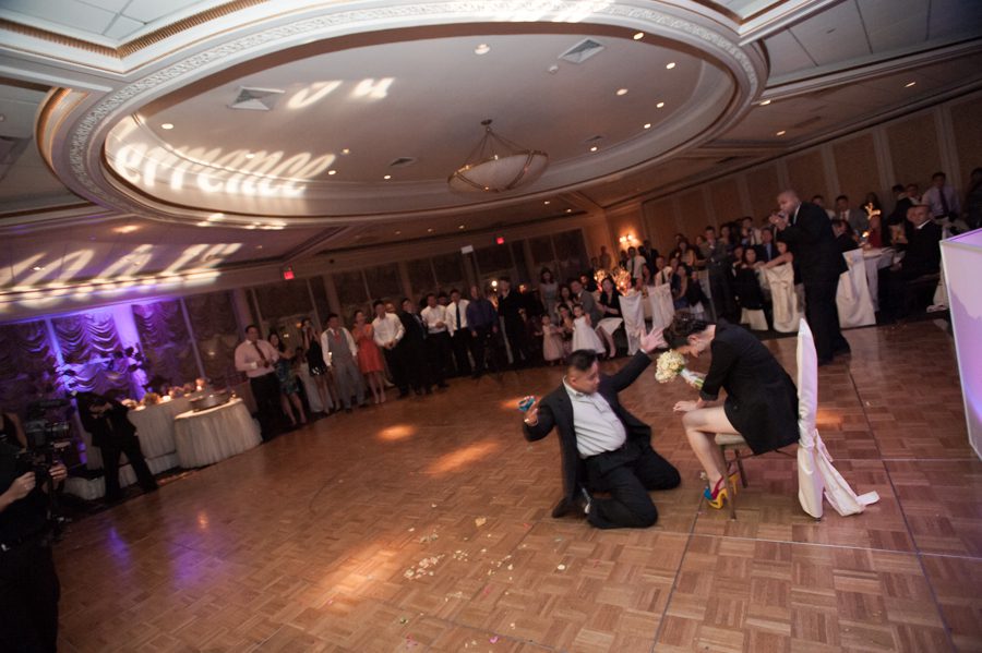 Garter toss at a wedding reception at the VIP Country Club in Westchester, NY. Captured by NYC wedding photographer Ben Lau.