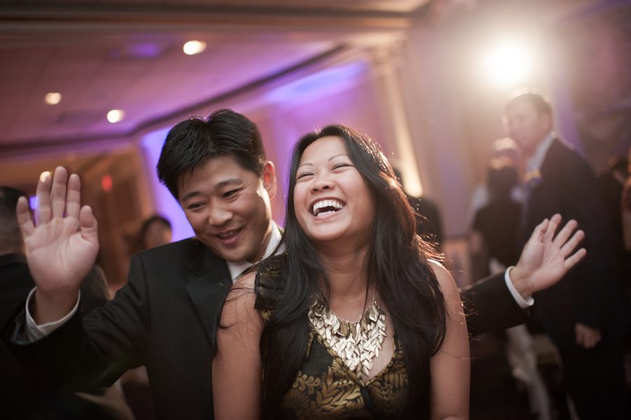 Guests dance during a wedding reception at the VIP Country Club in Westchester, NY. Captured by NYC wedding photographer Ben Lau.