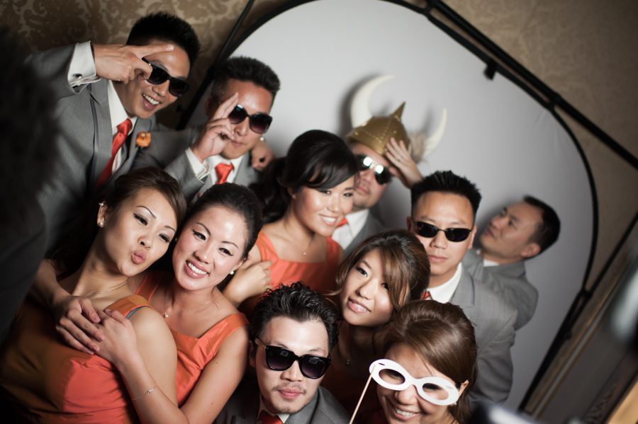 Guests pose for the photo booth during a wedding reception at the VIP Country Club in Westchester, NY. Captured by NYC wedding photographer Ben Lau.