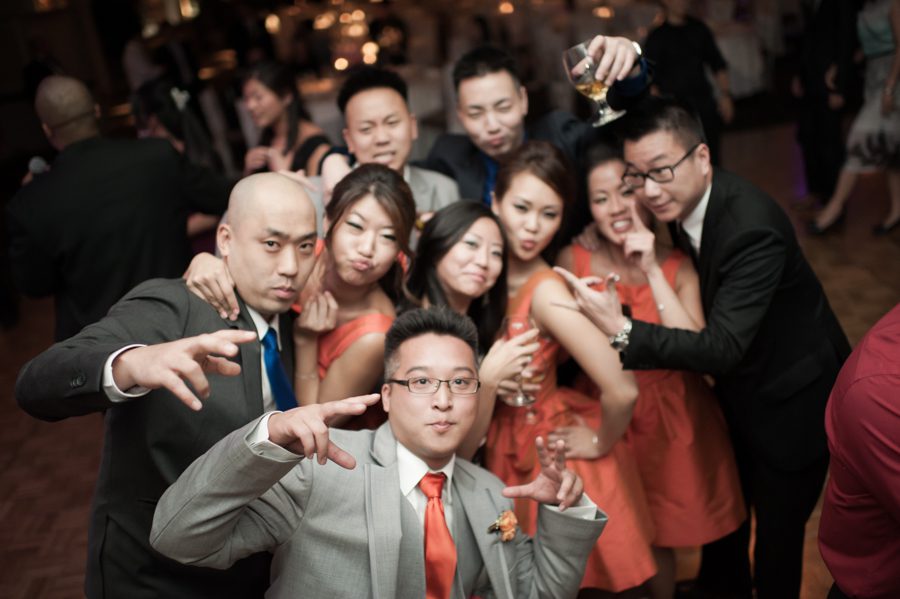 Guests pose for the camera during a wedding reception at the VIP Country Club in Westchester, NY. Captured by NYC wedding photographer Ben Lau.