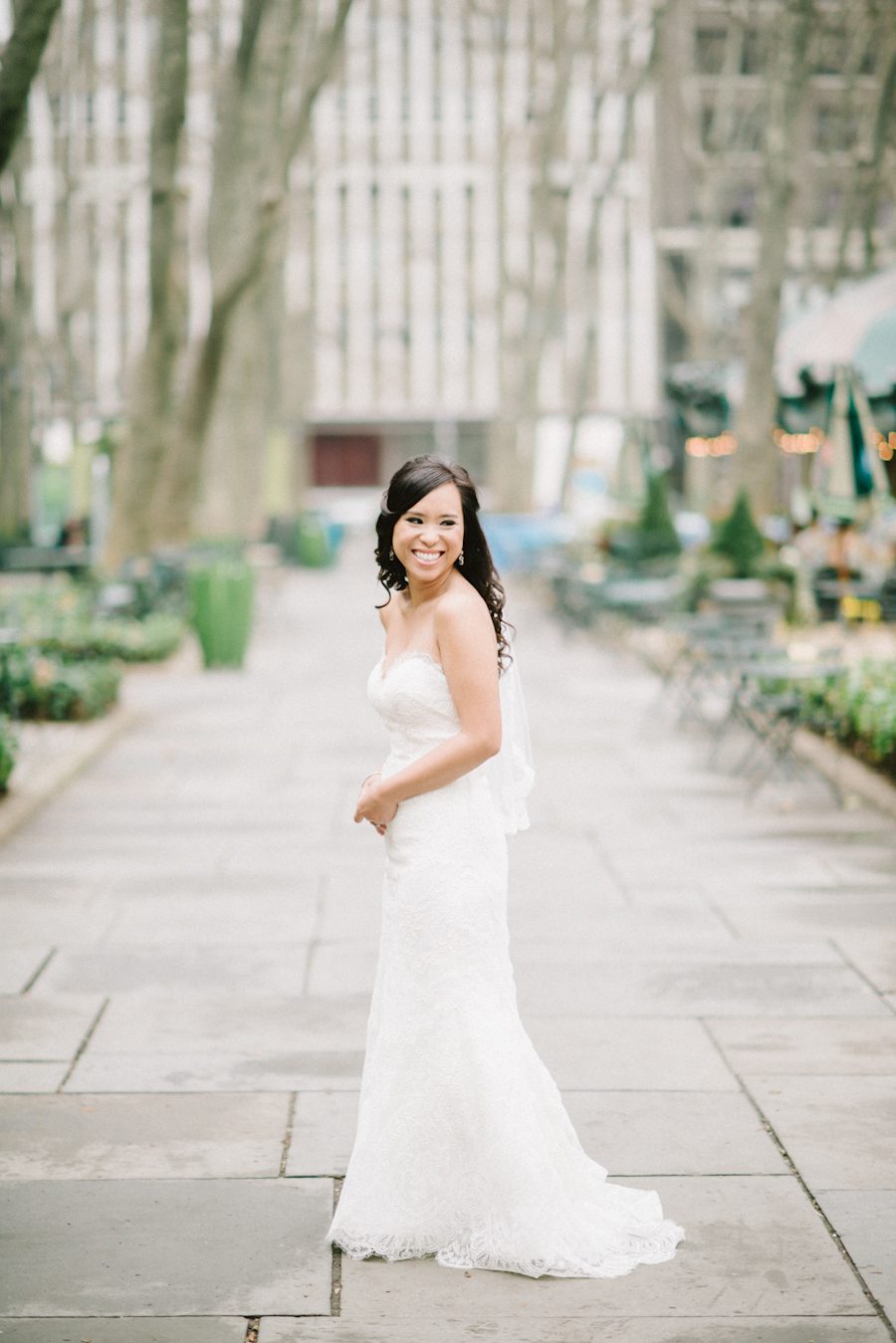 Bride poses for portraits at Bryant Park. Captured by NYC wedding photographer Ben Lau.
