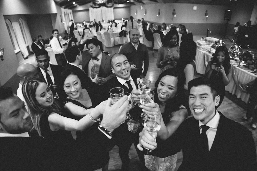 Guests toast during Chris and Rosalen's Douglaston Manor Wedding. Captured by NYC wedding photographer Ben Lau.