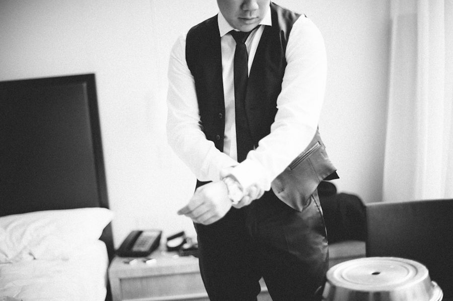 Groom preps in his Bryant Park Hotel room in NYC. Captured by NYC wedding photographer Ben Lau.