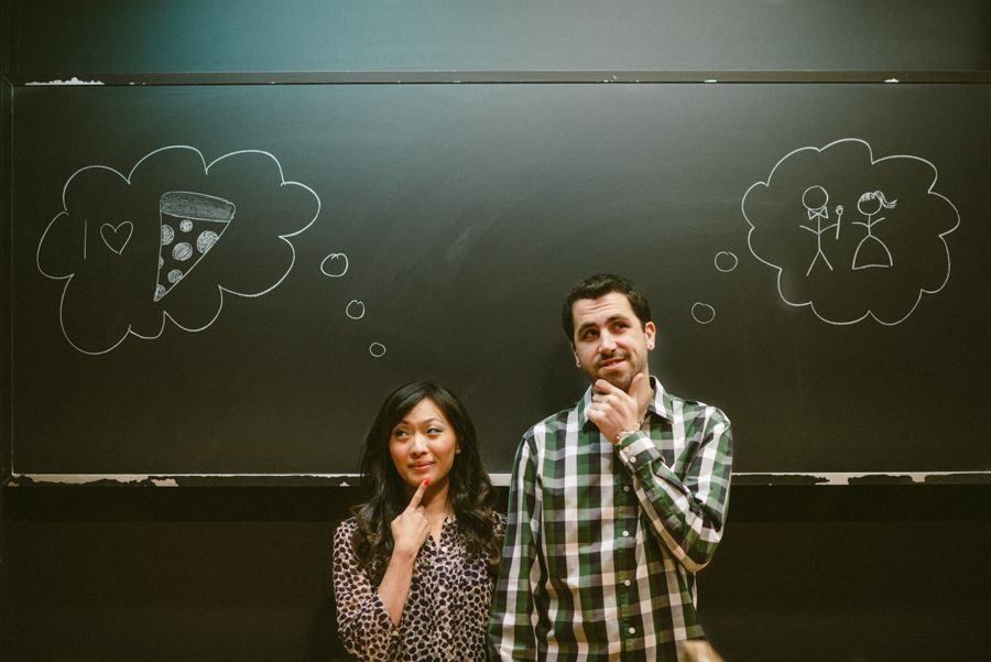 Julia and Jeff draw on a blackboard during their engagement session at a Princeton University.