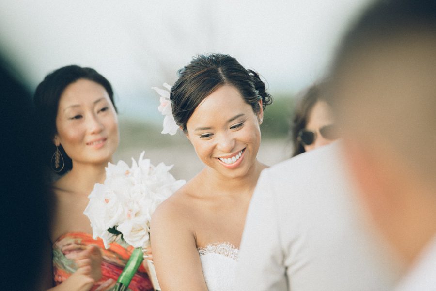 Bride smiles during her wedding in Aruba. Captured by destination wedding photographer Ben Lau.