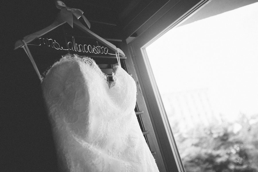 Wedding dress hangs by the window at the Radisson Aruba. Captured by destination wedding photographer Ben Lau.