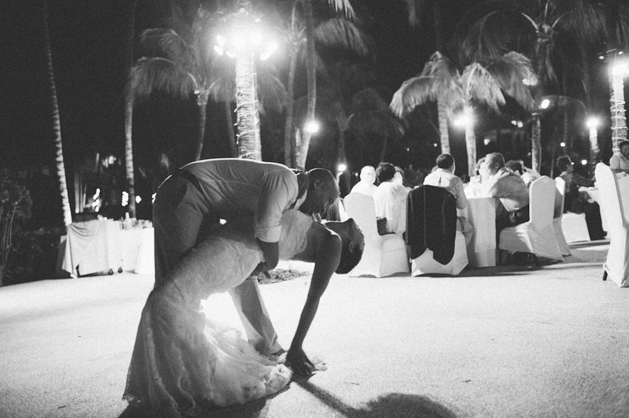 Groom dips bride during a Radisson Aruba wedding reception. Captured by destination wedding photographer Ben Lau.