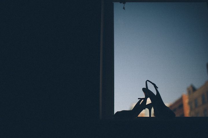 Wedding shoes on a windowsill at the Liberty House in Jersey City, NJ. Captured by NYC wedding photographer Ben Lau.