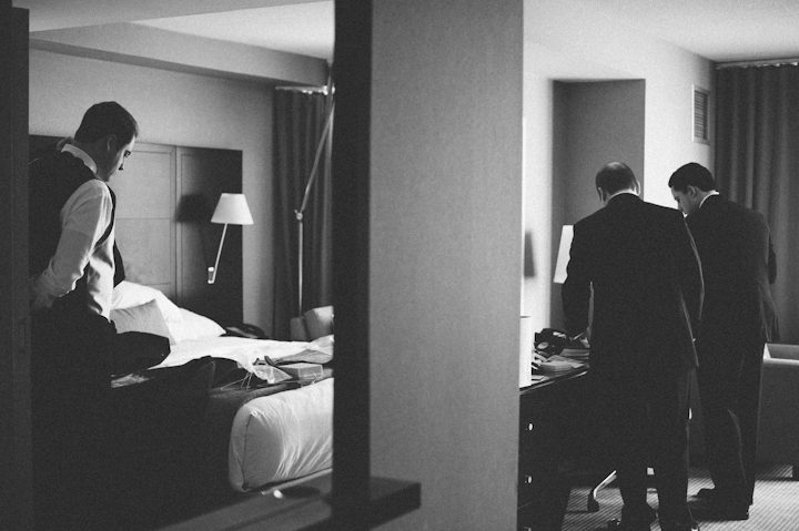 Groomsmen prep for a wedding day at the Hyatt in Jersey City, NJ. Captured by NYC wedding photographer Ben Lau.