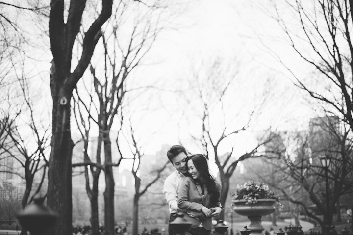 Couple poses for in Central Park for their engagement session in NYC. Captured by NYC wedding photographer Ben Lau.