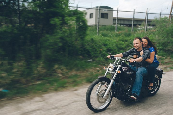 Michelle and Bryan ride their Harley Davidson during their Baltimore engagement session with Ben Lau Photography.