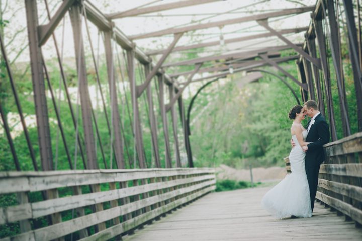 Kathleen and Tim pose on a bridge at the Phoenixville Foundry on the wedding day.