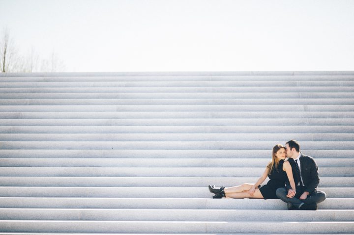 Couple sits on steps on Roosevelt Island, NY. Captured by NYC wedding photographer Ben Lau.