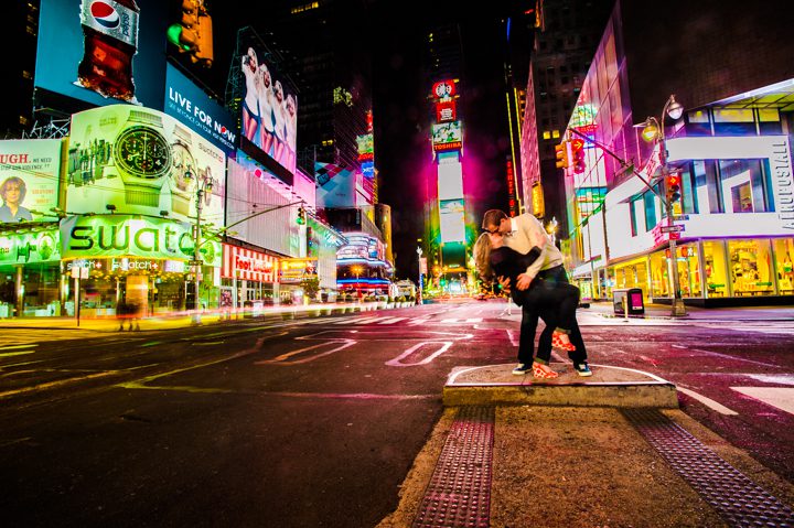Nick dips Karina on a corner in Times Square. Captured by NYC wedding photographer Ben Lau.
