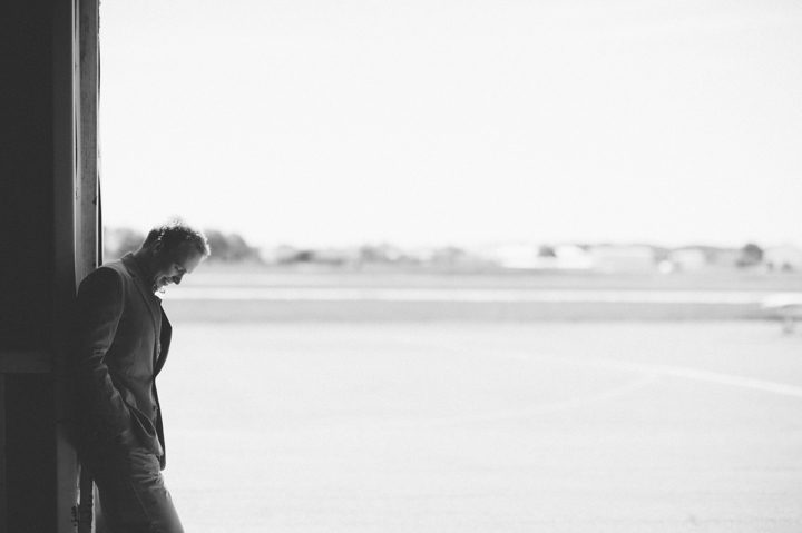 Groom solo during his engagement session at an airfield in Philadelphia, PA. Captured by NJ wedding photographer Ben Lau.