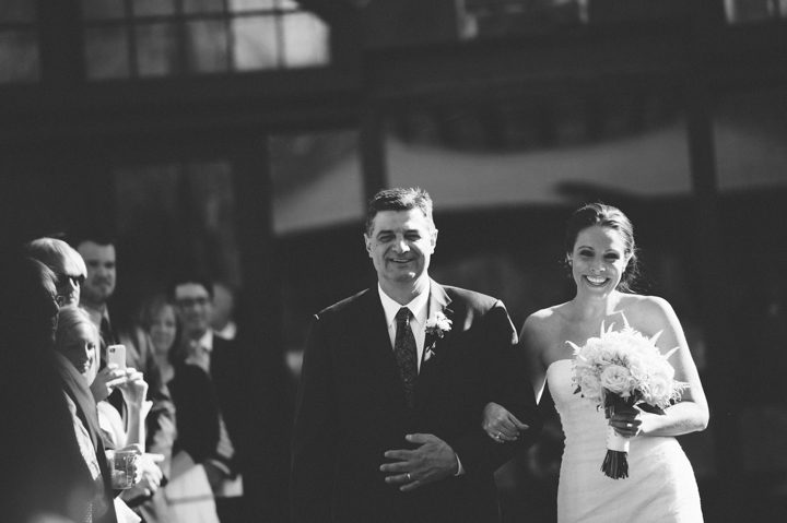 Father walks his daughter down the aisle at the Phoenixville Foundry in Phoenixville, Pa. Captured by Northern NY wedding photographer Ben Lau.