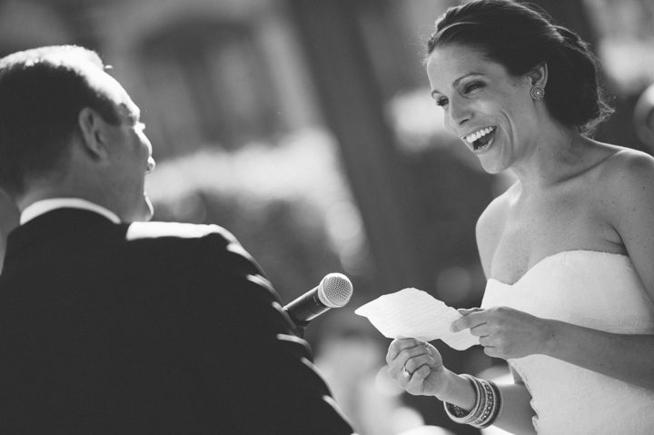 Bride laughs during her wedding ceremony at the Phoenixville Foundry in Phoenixville, Pa. Captured by Northern NY wedding photographer Ben Lau.