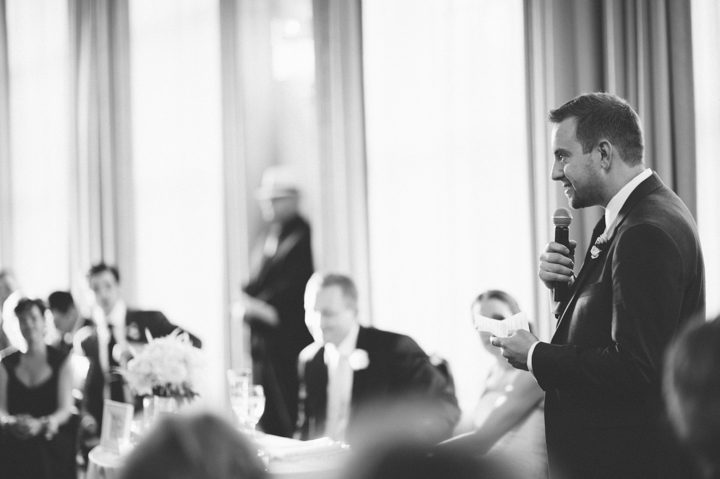 Best man makes a speech during a wedding reception at the Phoenixville Foundry in Phoenixville, Pa. Captured by Northern NY wedding photographer Ben Lau.
