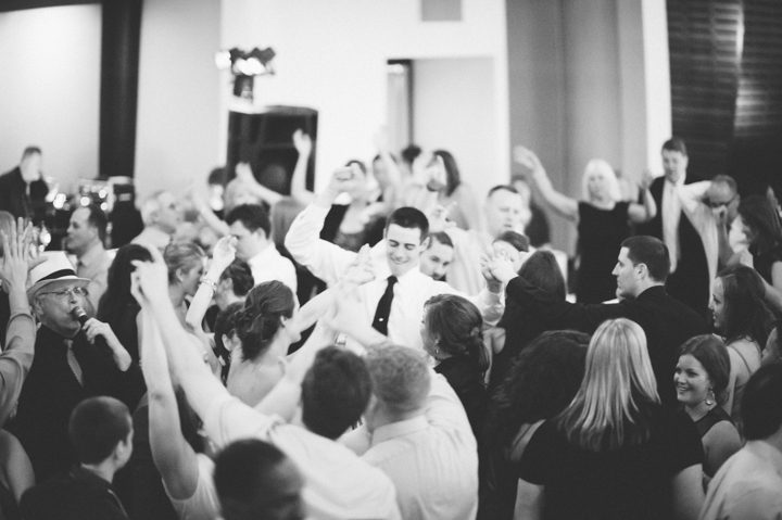 Wedding guests dance during a wedding reception at the Phoenixville Foundry in Phoenixville, Pa. Captured by Northern NY wedding photographer Ben Lau.