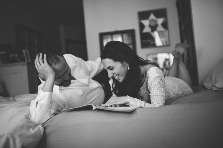 Nicole and Matt lay in their bed in their apartment during their engagement session in the West Village with NYC wedding photographer Ben Lau.