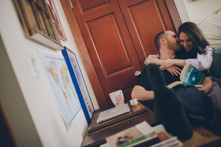 Nicole hugs Matt in their apartment during their engagement session in the West Village with NYC wedding photographer Ben Lau.
