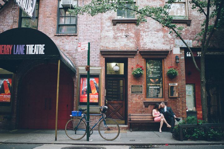 A couple sits on a bench during their engagement session in the West Village with NYC wedding photographer Ben Lau.