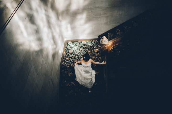 Bride descends the stairs on the morning of her wedding at the Hempstead House in Sands Point Preserve, Long Island. Captured by NYC wedding photographer Ben Lau.