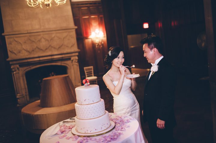 Cake cutting during a wedding at the Hempstead House in Sands Point Preserve, Long Island. Captured by NYC wedding photographer Ben Lau.