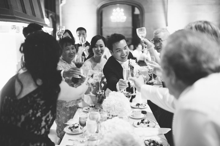 Toasts during a wedding reception at the Hempstead House in Sands Point Preserve, Long Island. Captured by NYC wedding photographer Ben Lau.