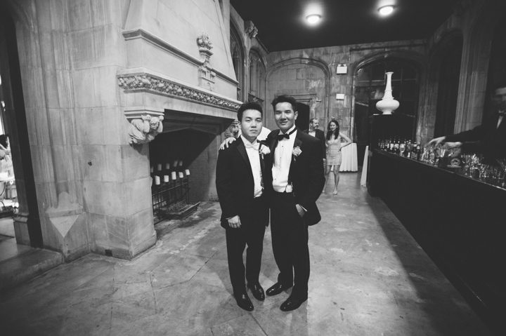 Groom and Best Man pose together for a casual photo during a wedding reception at the Hempstead House in Sands Point Preserve, Long Island. Captured by NYC wedding photographer Ben Lau.