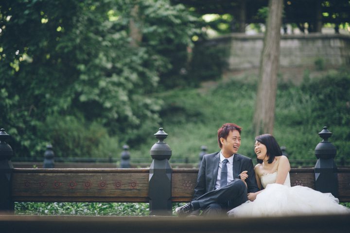 Bride and groom laugh together in Central Park during during their bridal session with NYC wedding photographer Ben Lau.