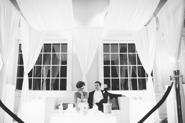 Bride and groom in their booth during their wedding reception at the Old Tappan Manor in Old Tappan, NJ. Captured by Northern New Jersey Wedding Photographer Ben Lau.