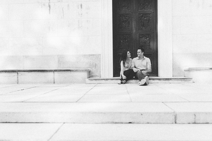 Couple sit in the doorway during their engagement session in Morristown with NJ wedding photographer Ben Lau.