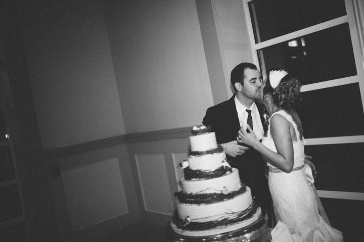 Bride and groom cut their wedding cake during their wedding at the Stone House in Stirling Ridge. Captured by NJ wedding photographer Ben Lau.