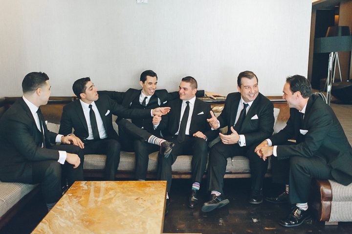 Groom and his groomsmen share a moment during a Tribeca Rooftop Wedding, captured by NYC wedding photographer Ben Lau.