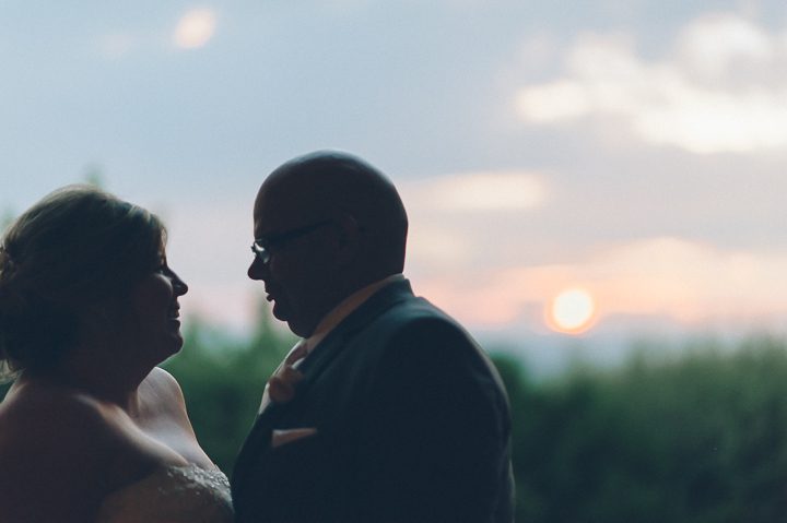 Couple smiling at sunset at the Westmount Country Club on their wedding day.