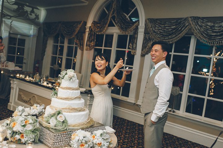 Cake cutting during a wedding reception at Falkirk Estates in Central Valley, NY. Captured by NYC wedding photographer Ben Lau.