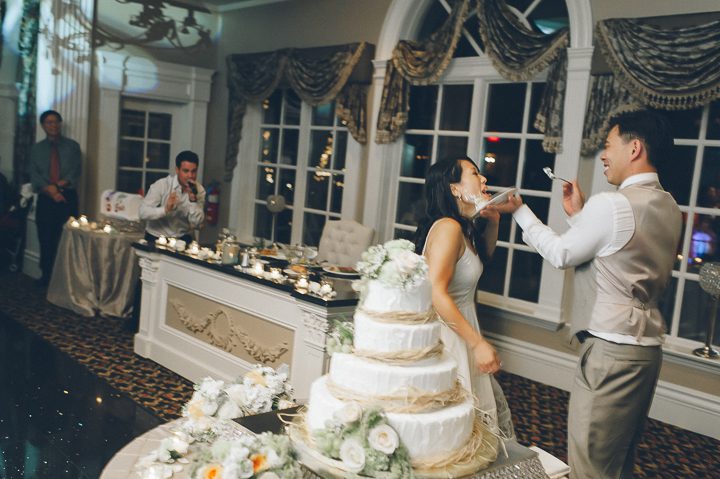 Cake cutting during a wedding reception at Falkirk Estates in Central Valley, NY. Captured by NYC wedding photographer Ben Lau.