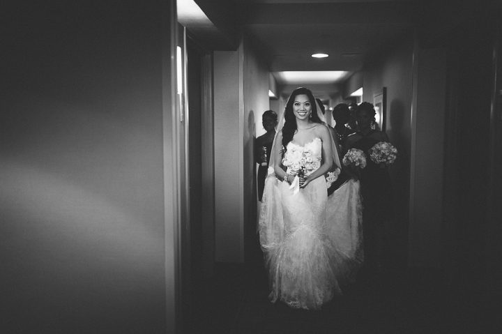 Bridal party walks down the hall at the Hyatt Regency in Crystal City, VA. Captured by NYC wedding photographer Ben Lau.